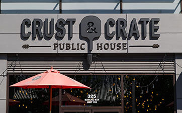 Image of the front door of Crust & Crate restaurant at TD Place