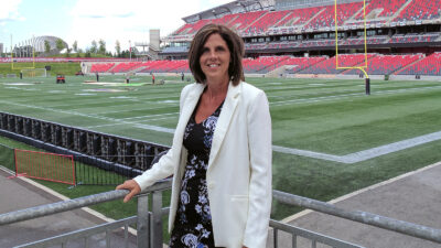 Image of Janice Barresi standing next to the football field