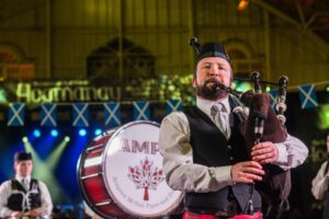 Image of a male performer playing the bag pipes